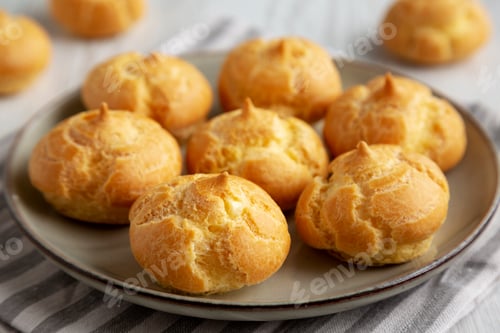 Preview: Homemade French Mini Cream Puffs on a Plate, side view.