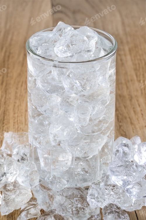 Preview: Glass of cold water with ice on wooden table