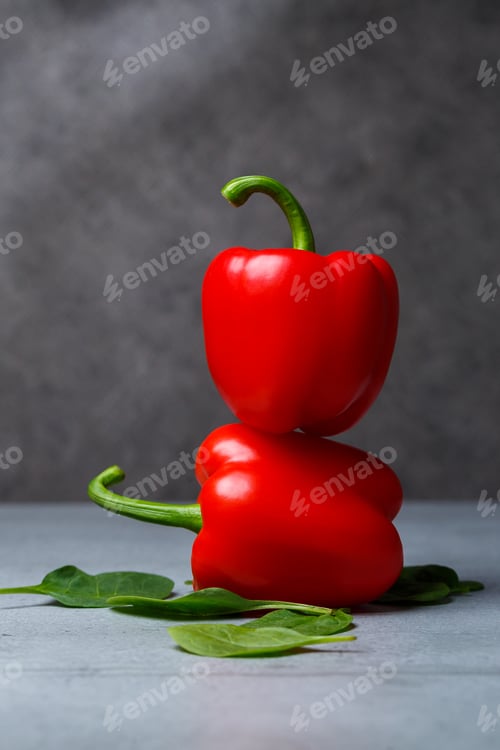 Preview: Red pepper with spinach on a gray table