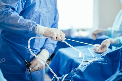 Preview: Close up of surgeon hands during operation receiving assistance from nurse.