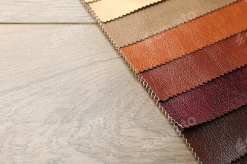 Preview: Samples of different fabrics on wooden table, closeup. Space for text
