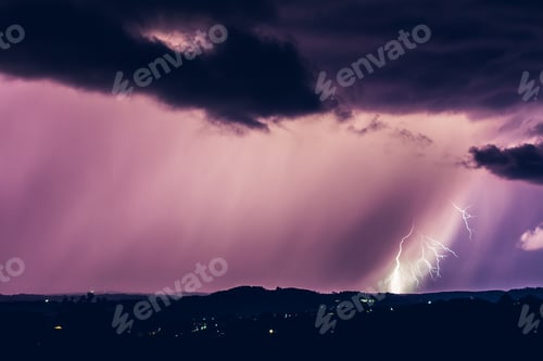 Preview: Night landscape on a background of thunderstorms. Rural silhouette and clouds with lightning flashes