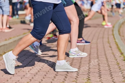 Preview: Young woman warming up before running marathon