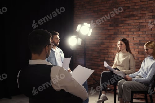 Preview: Professional actors reading their scripts during rehearsal in theatre