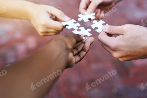 Preview: Finding solutions piece by piece. Shot of hands putting puzzle pieces together.