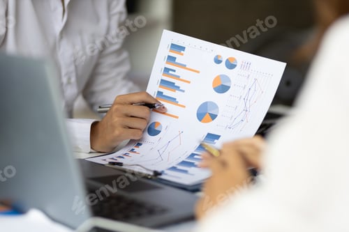 Preview: Business people analyzing chart, financial report and market growth plan business strategies.