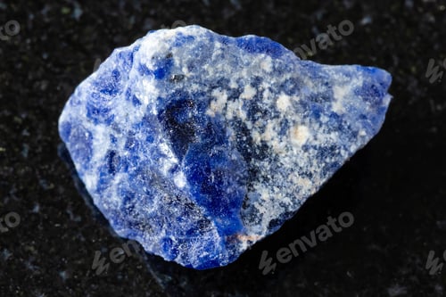 Preview: sample of raw sodalite mineral on black granite