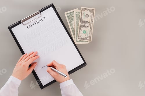 Preview: Hands of business woman signing business agreement.