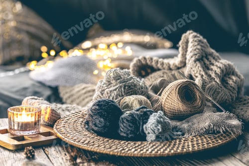 Preview: Cozy composition with balls of thread and a knitted element in the interior.