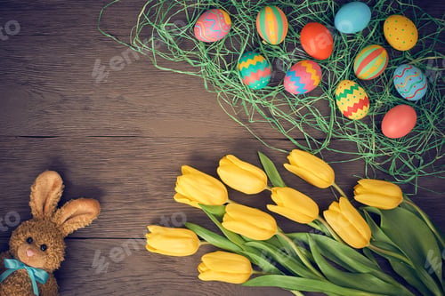 Colorful Easter Eggs and Yellow Tulips on Wood