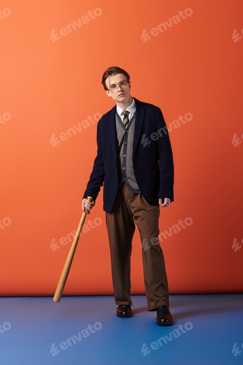 Preview: Stylish teenager stands confidently with a baseball bat against a vibrant backdrop