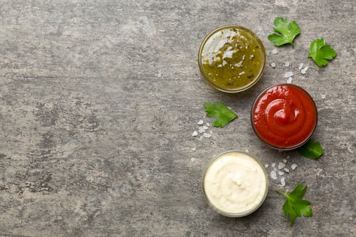 Vista previa: Many different sauces and herbs on table, flat lay top view. sauces with spices healthy concept