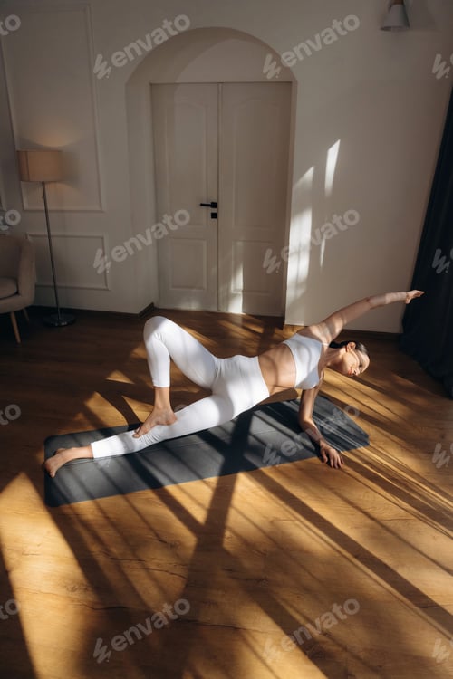 Preview: Shadow and sunlight, doing yoga. Young woman in fitness clothes is in the room