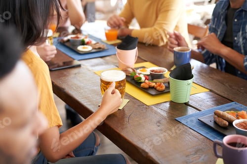 Preview: Friends in the terrace bar Pub. Drinking beer, talking, having fun. Friendship and community concept