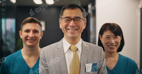 Preview: Portrait, doctors and business with Japanese man in hospital for leadership, teamwork and healthcar