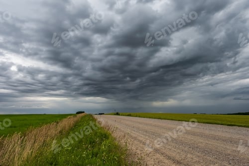 Preview: panorama of black sky background with storm clouds. thunder front over gravel road