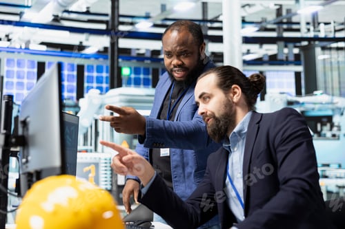 Preview: Industrial experts business partners work as team to refine manufacturing process