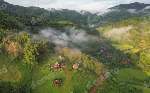 Preview: Aerial view from drone of the rural village in the mountains on foggy day
