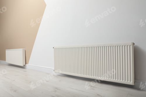 Preview: Modern radiators on color wall indoors. Central heating system