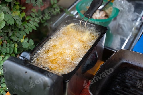 Preview: Deep frying French Fries in deep fryer