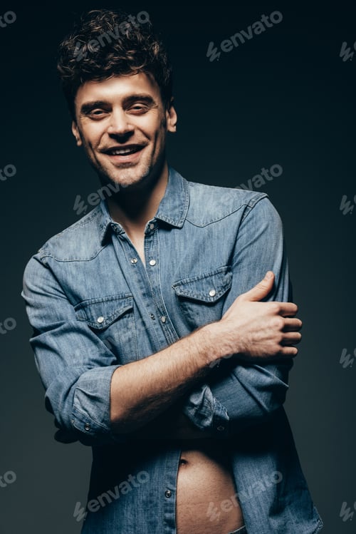 Preview: handsome laughing man posing in denim clothes isolated on grey