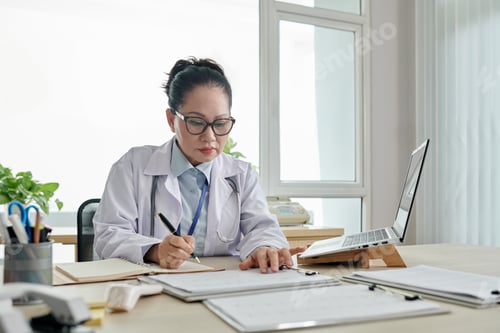 Preview: Female doctor working with documents at office