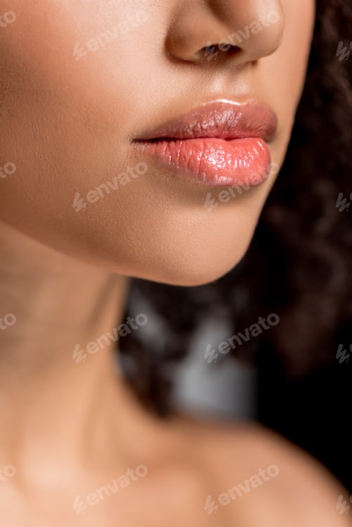 Preview: cropped view of african american girl with beautiful lips, on grey