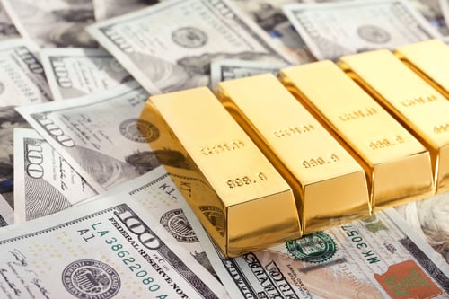 Preview: Shiny gold bars on pile of dollar bills