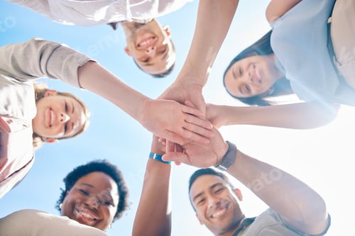 Preview: Group of happy, young colleagues or friends hands stack for unity, teamwork and collaboration and o