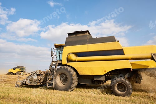 Preview: Large Agricultural Combine Harvesting Wheat Crop on Sunny Rural Farmland