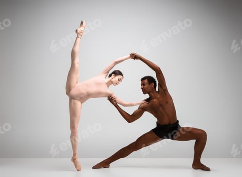 Preview: Couple of ballet dancers posing over gray background