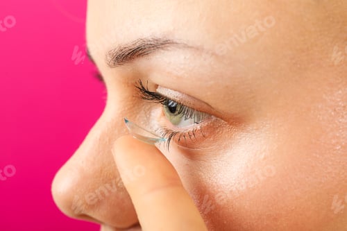 Preview: Installation of a contact lens in the eye close-up