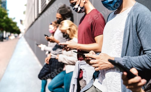 Preview: Side view of friends using mobile phone covered by face mask