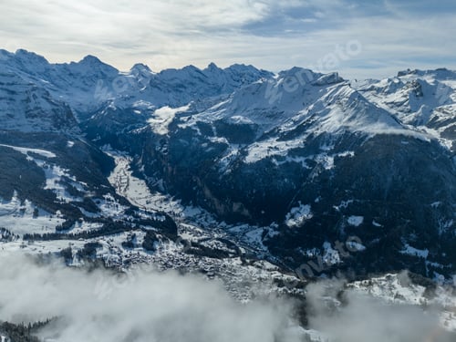Preview: Lauterbrunnen Valley and Snowy Mountains in Winter. Switzerland. Aerial View