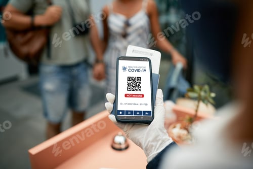 Preview: Close up of non immune COVID-19 vaccination certificate on guests mobile app check-in hotel.