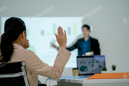 Preview: Business woman raise her hand up to ask the question to Asian business man as presentor during work