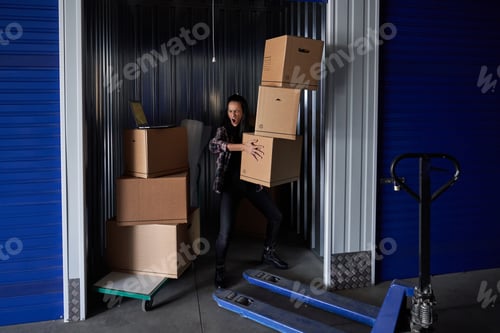 Preview: Woman carrying heavy boxes in container