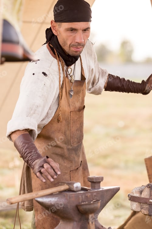 Preview: blacksmith works outdoors. Makes a horseshoe with tools