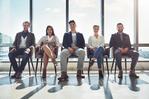 Preview: Portrait of a group of businesspeople sitting in line in an office