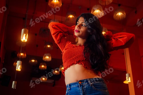 Preview: india girl long hair in red blouse stang lighting diyas in dark room