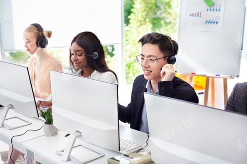 Preview: Team of helpline operators with headsets consulting clients at call center