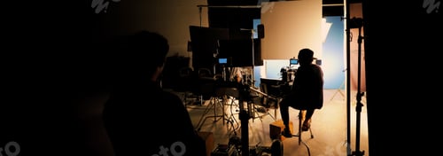 Preview: Silhouette of film crews and video camera on special dolly crane with film lights and set.