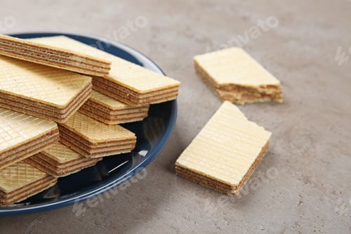 Preview: Plate of delicious wafers on grey stone background