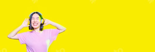 Preview: Young asiatic woman listening music laughing isolated