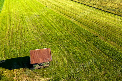 Preview: old wooden house on a green field