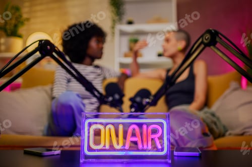 Preview: Neon on air sign standing on a table in a studio while recording podcast