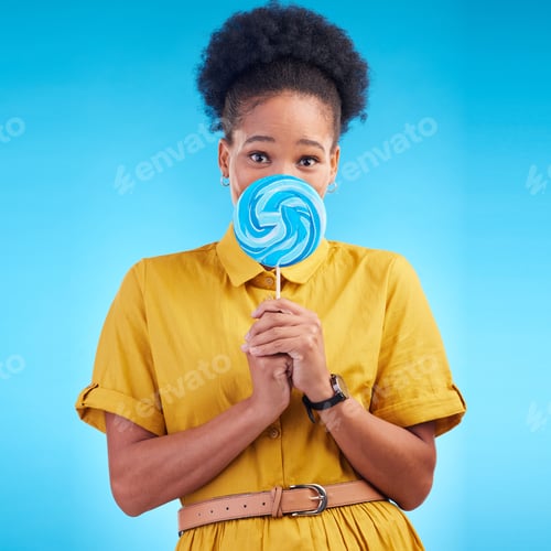 Preview: Happy, candy and portrait of a black woman on a studio background for a lollipop, excited and eatin