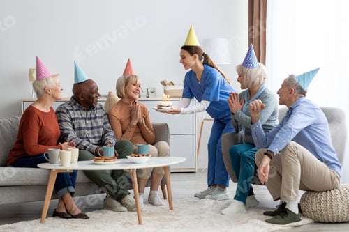 Preview: Group of elderly people having birthday party at nursing home