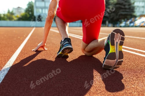 Preview: Cropped image of male athlete, runner training at public stadium, sport court or running track