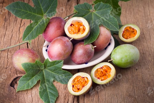 Preview: fruits of gulupa on vine wood table, Passiflora pinnatistipula